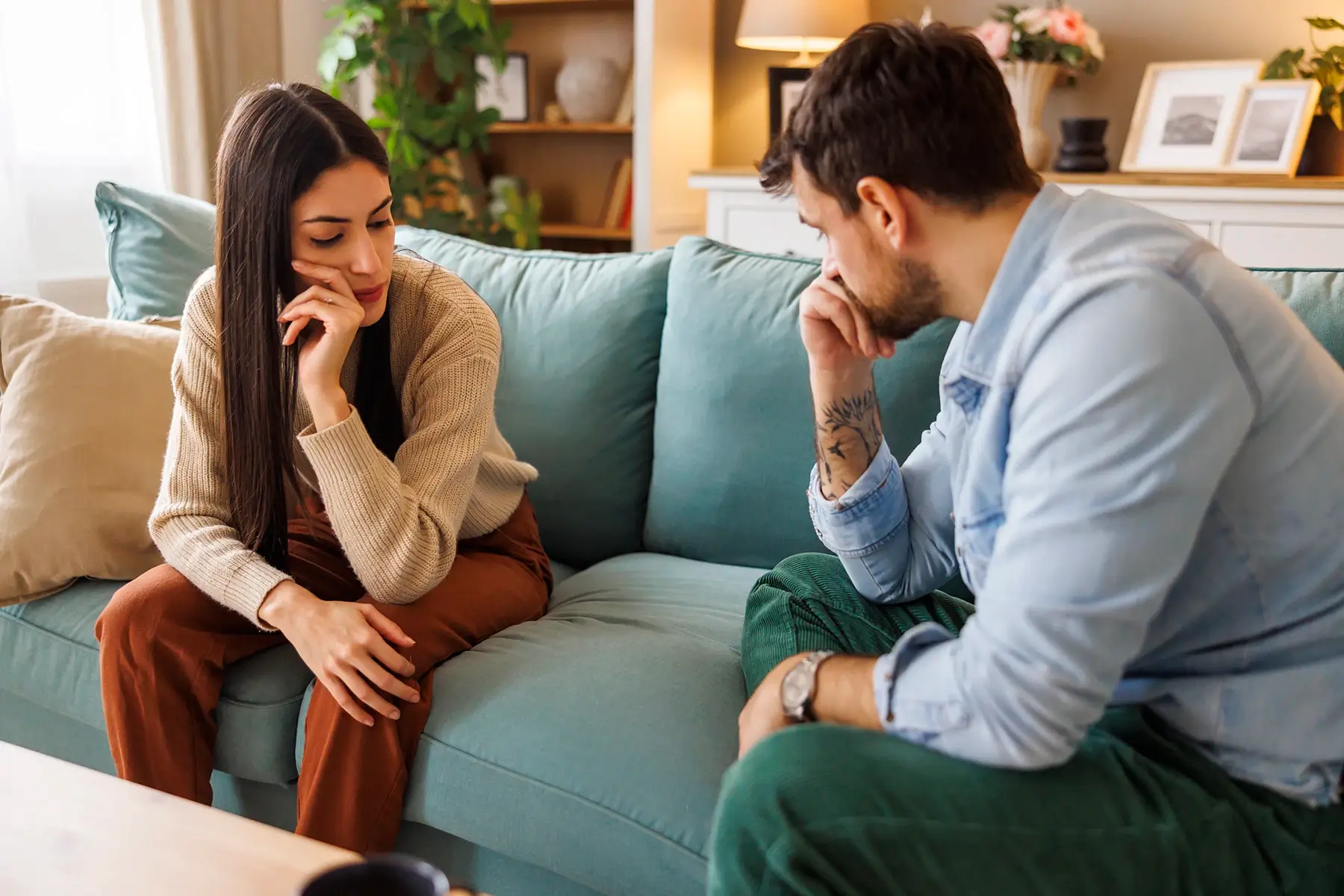 Couple discussing their divorce on a couch - Wilmington, NC collaborative divorce lawyer