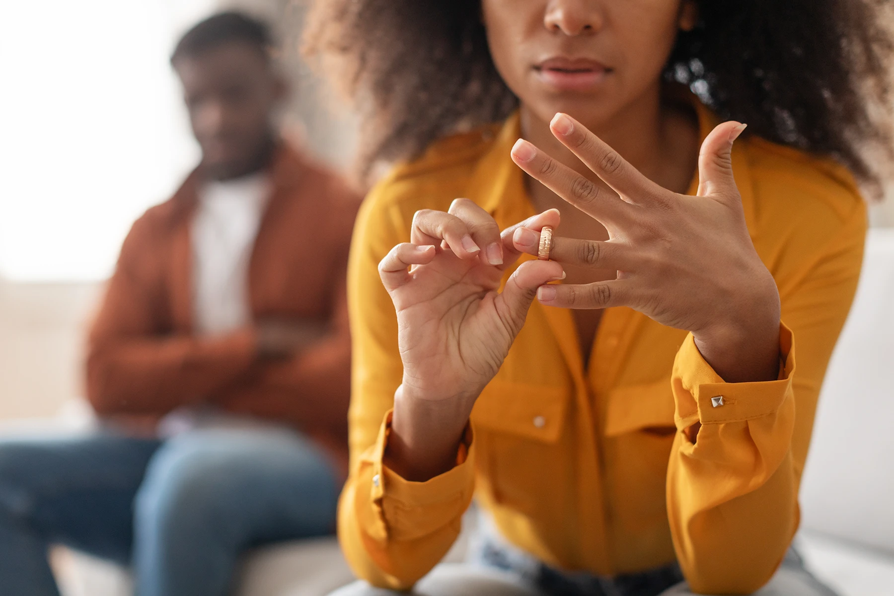 Woman removing her wedding ring - Wilmington, NC contested divorce lawyer