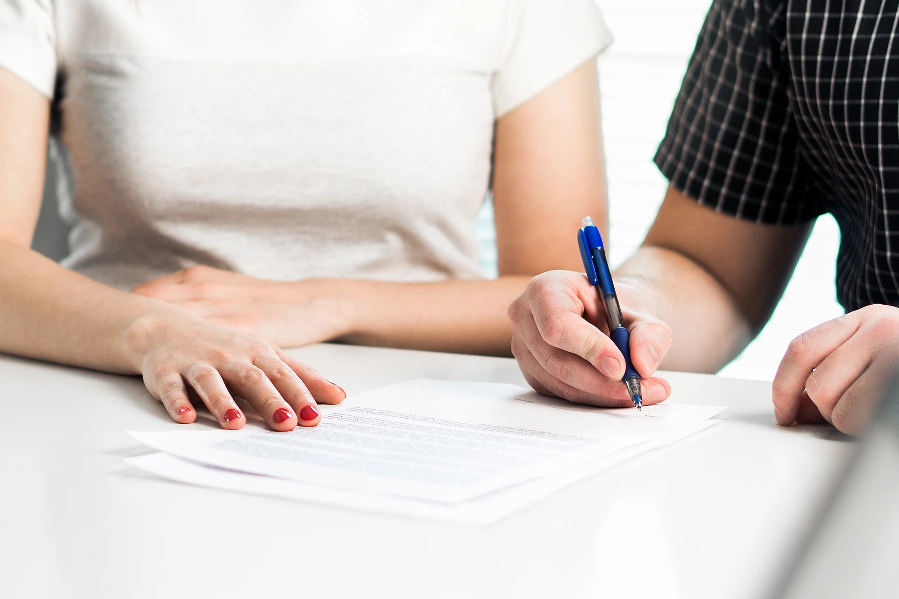 Couple signing a marital agreement - Wilmington, NC prenuptial and postnuptial agreements