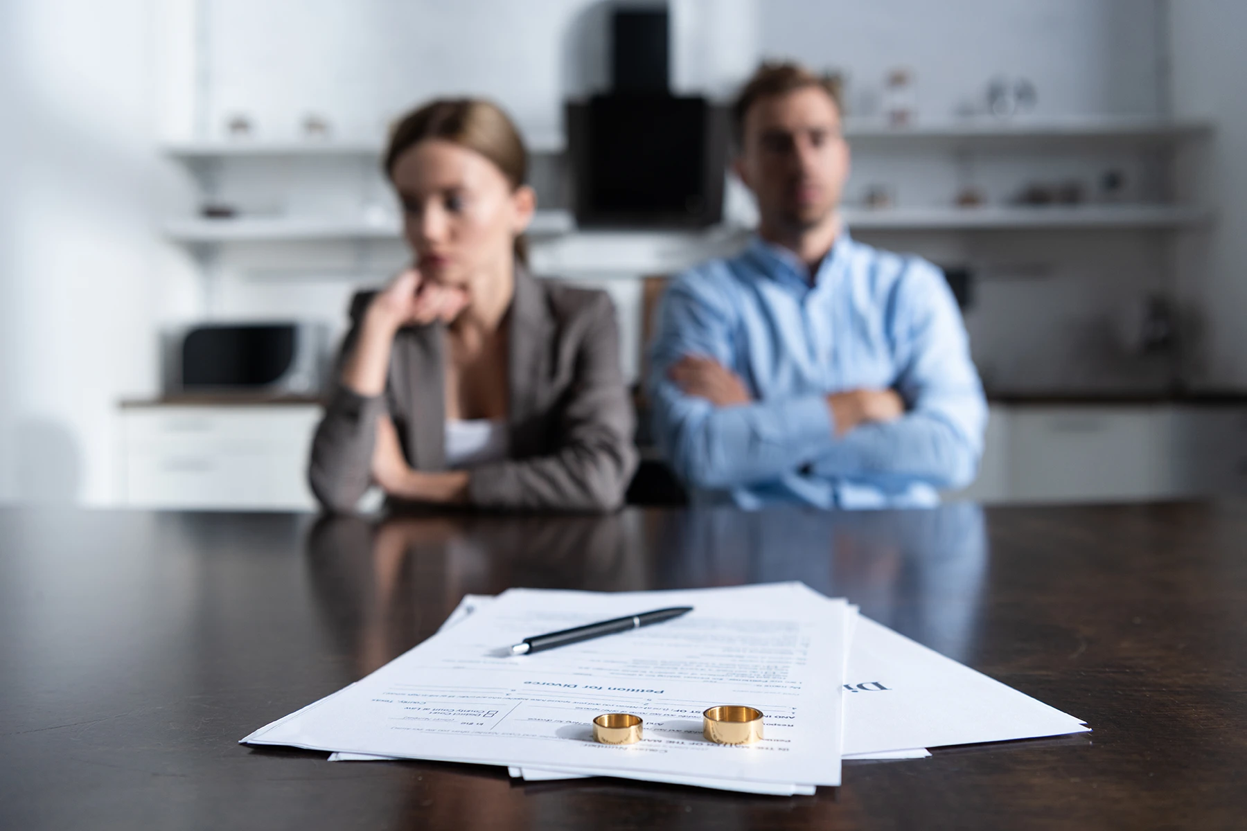 Couple with divorce papers and wedding rings - Wilmington, NC uncontested divorce lawyer
